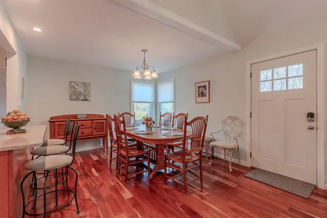 a view of a dining room with furniture and chandelier