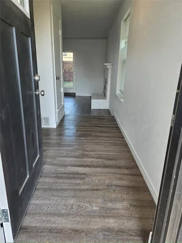 a view of a hallway view with wooden floor and staircase