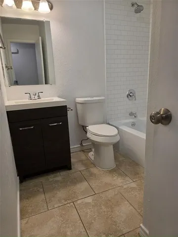 a bathroom with a sink vanity mirror and toilet
