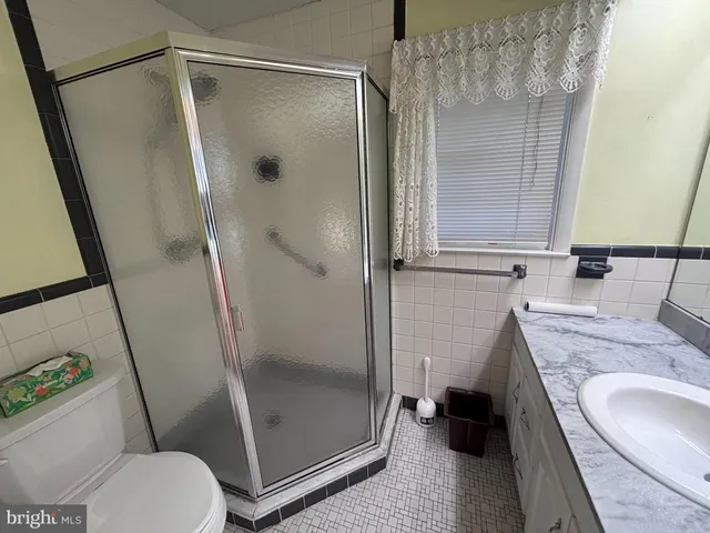 a bathroom with a granite countertop sink mirror and double