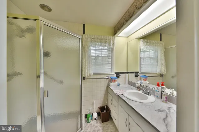 a bathroom with a sink mirror and toilet