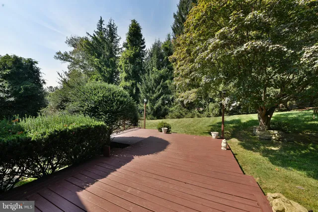 a balcony with wooden floor and yard