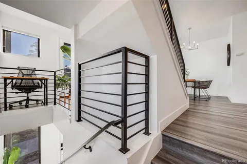 a kitchen with a dining table chairs stove and white cabinets