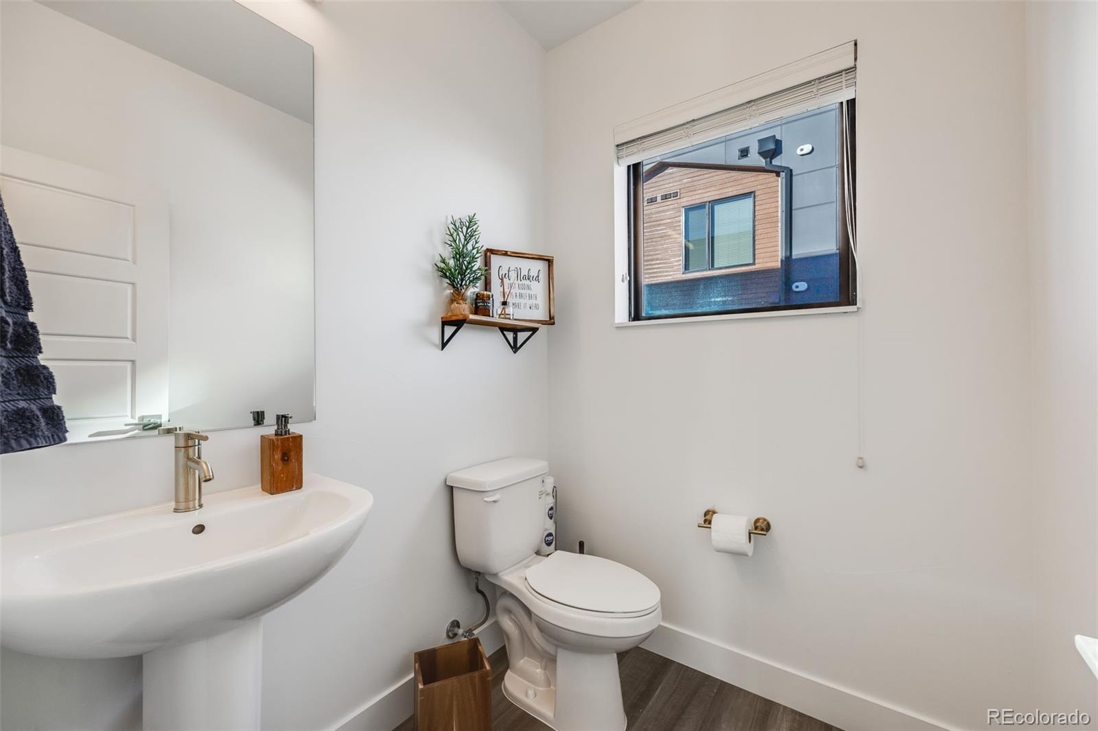 3011 West 53rd Avenue Denver, CO 80221 - Photo 18 of 44 a bathroom with a toilet sink and mirror