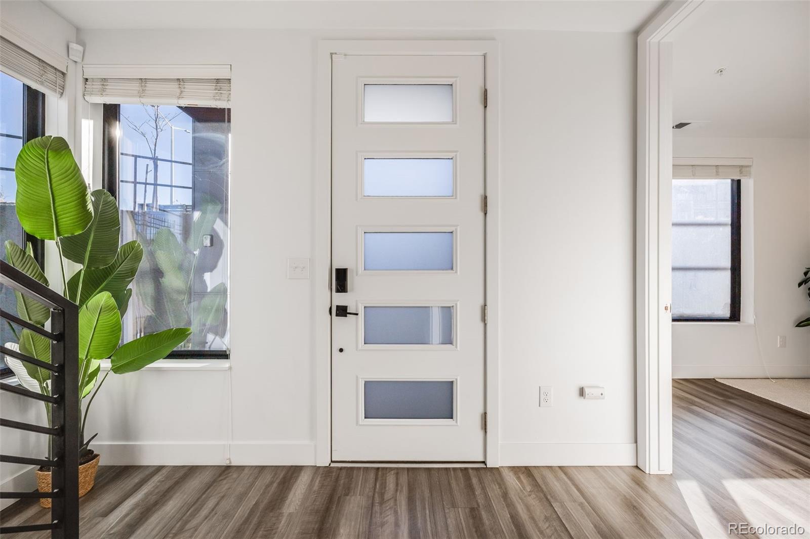 3011 West 53rd Avenue Denver, CO 80221 - Photo 2 of 44 a view of a hallway with wooden floor and entryway