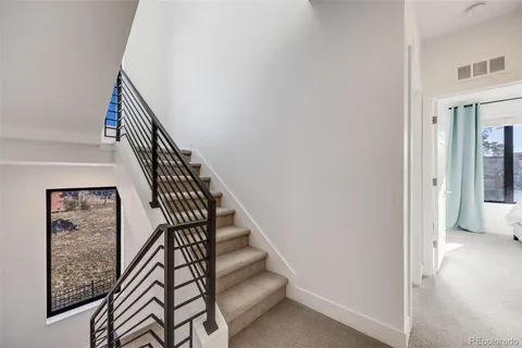 a bedroom with a bed and large window