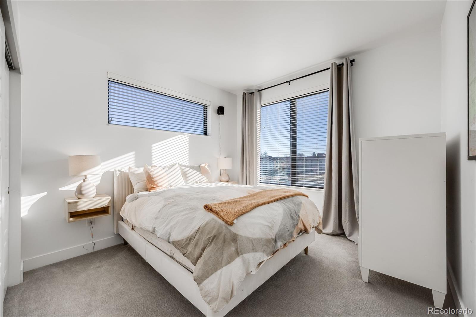 3011 West 53rd Avenue Denver, CO 80221 - Photo 25 of 44 a bedroom with a bed and large window