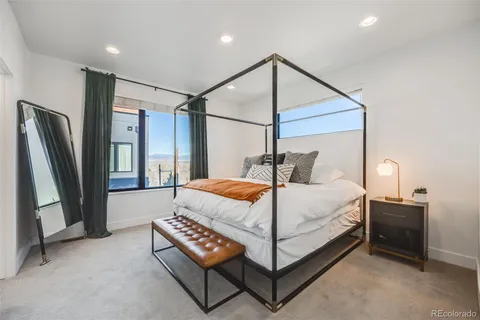 a bedroom with a large bed and a window