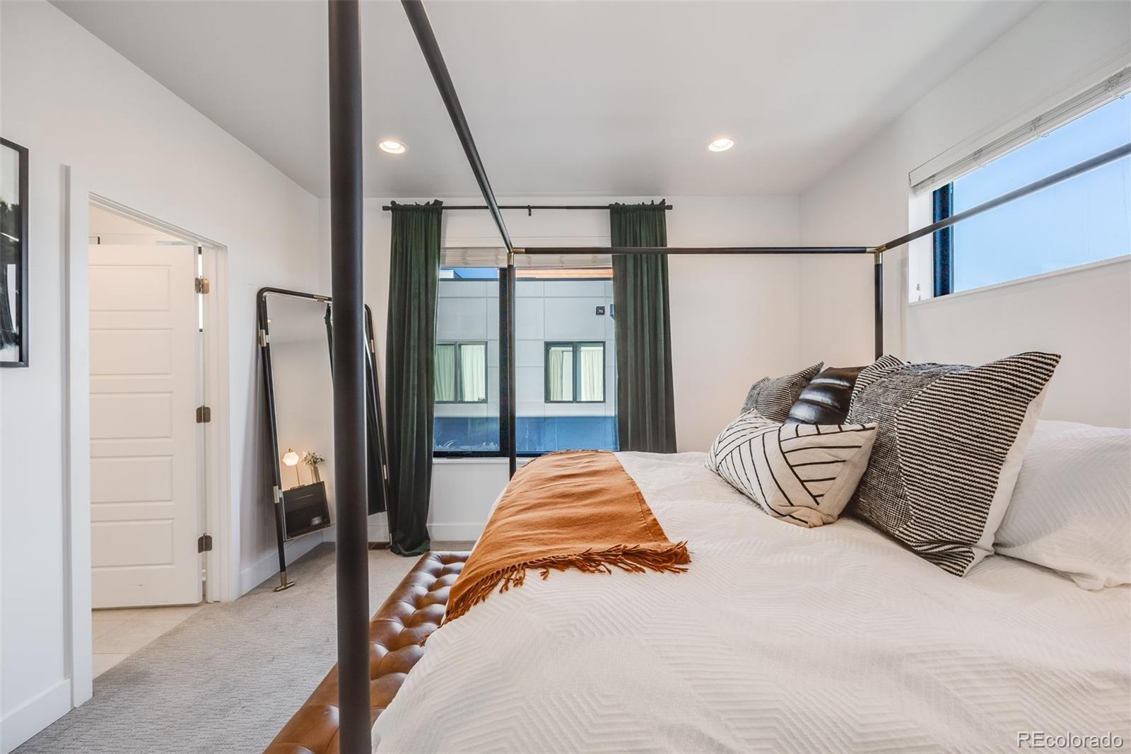 3011 West 53rd Avenue Denver, CO 80221 - Photo 29 of 44 a bedroom with a large bed and a window