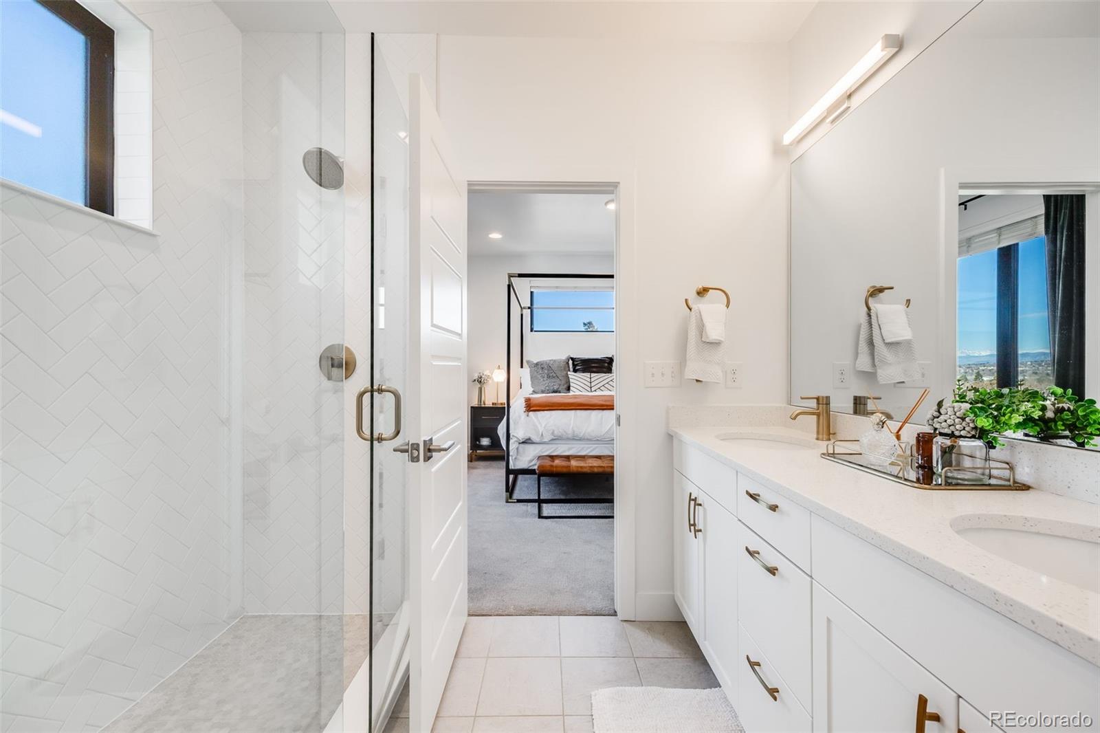3011 West 53rd Avenue Denver, CO 80221 - Photo 33 of 44 a en suite bathroom with a granite countertop sink mirror and shower