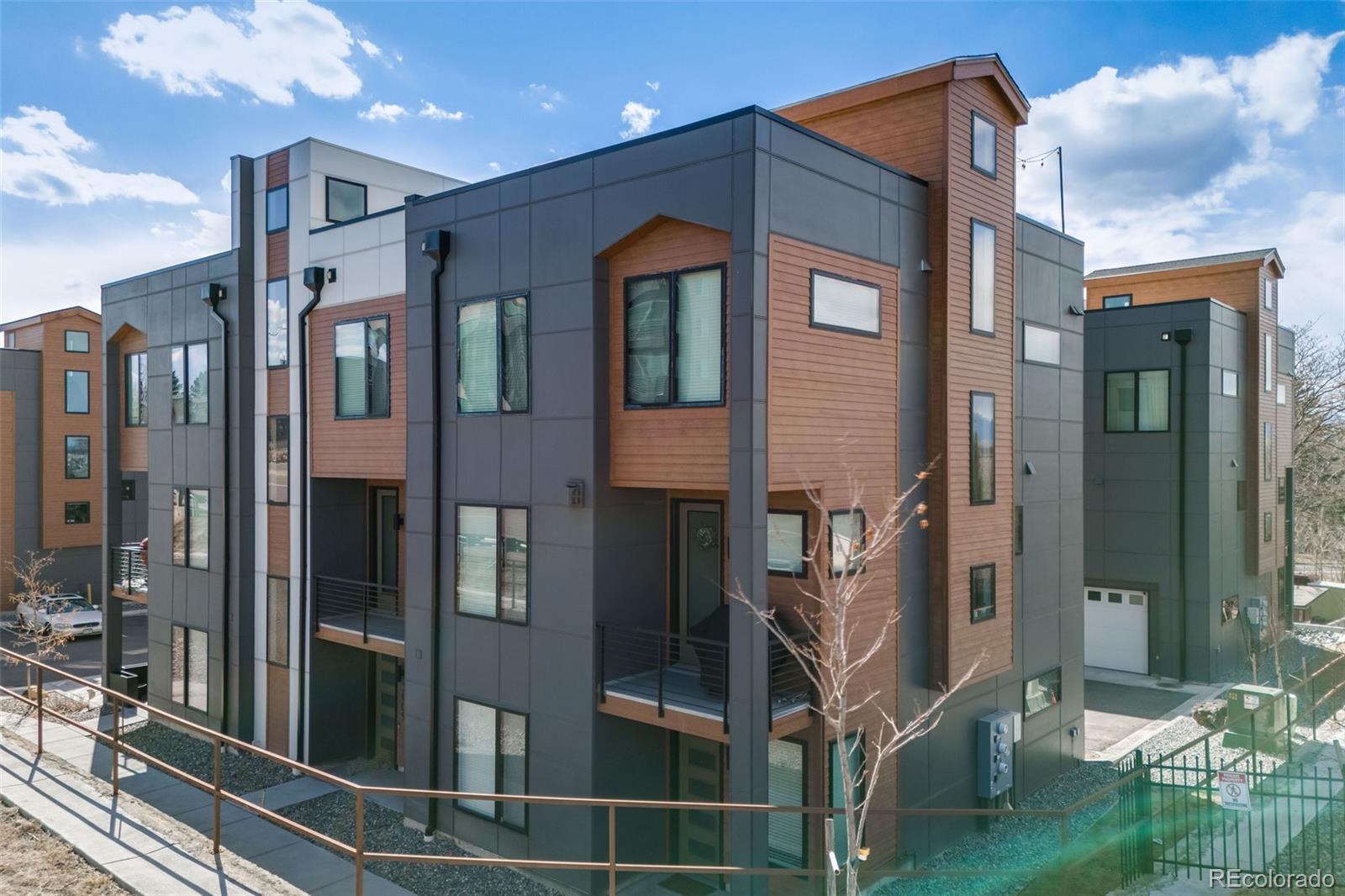 3011 West 53rd Avenue Denver, CO 80221 - Photo 4 of 44 a front view of a building with a glass door