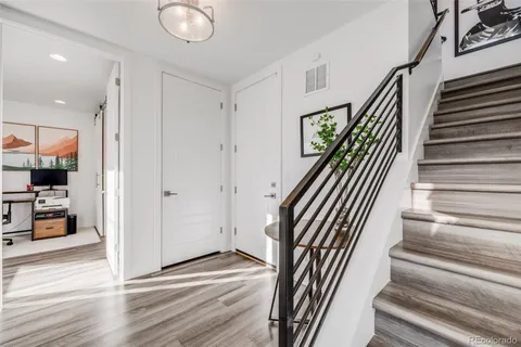 a view of entryway dining room and hall with wooden floor