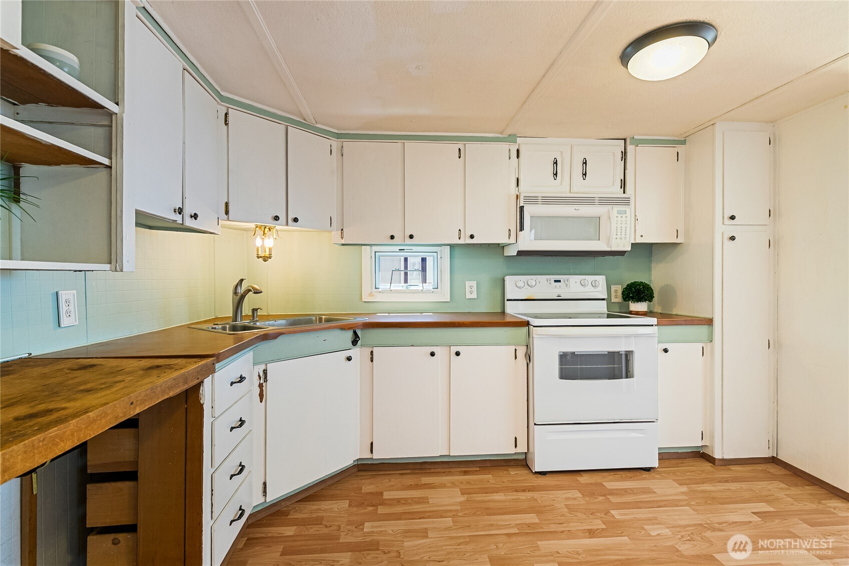 8080 Harborview Road, Unit 167 Blaine, WA 98230 - Photo 14 of 27 a kitchen with granite countertop a sink stainless steel appliances and cabinets