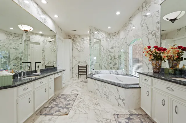 a spacious bathroom with a sink double vanity and a shower