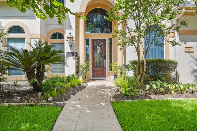 a front view of a house with a garden