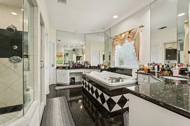 a kitchen with stainless steel appliances granite countertop a stove a sink dishwasher and a refrigerator with wooden floor