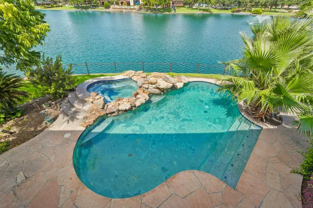 an aerial view of a house with a lake view