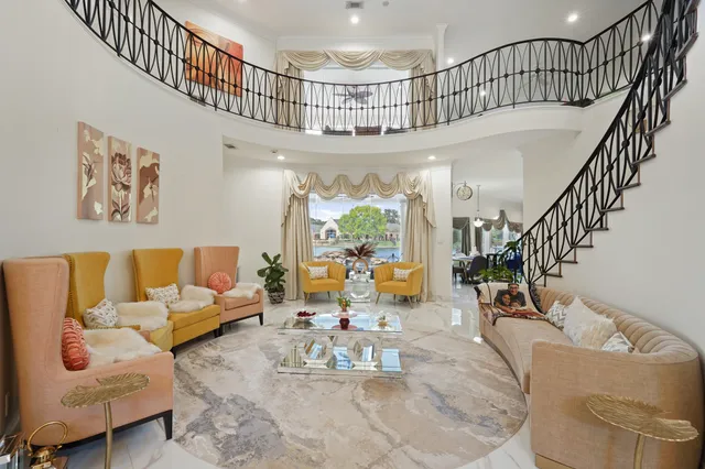 a living room with furniture or chandelier and a potted plant