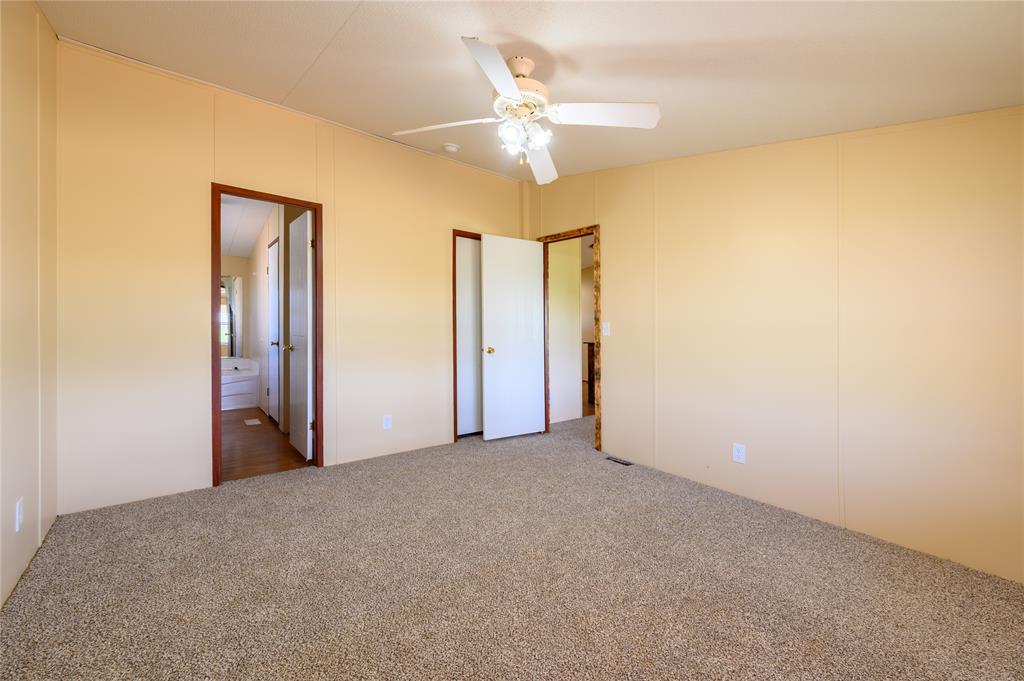 383 Soaring Eagle Trail Wichita Falls, TX 76310 - Photo 14 of 36 Unfurnished bedroom featuring carpet, ceiling fan, and ensuite bathroom
