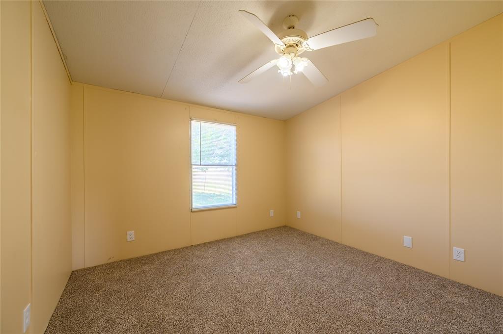 383 Soaring Eagle Trail Wichita Falls, TX 76310 - Photo 19 of 36 Carpeted spare room featuring a decorative wall, ceiling fan, and lofted ceiling