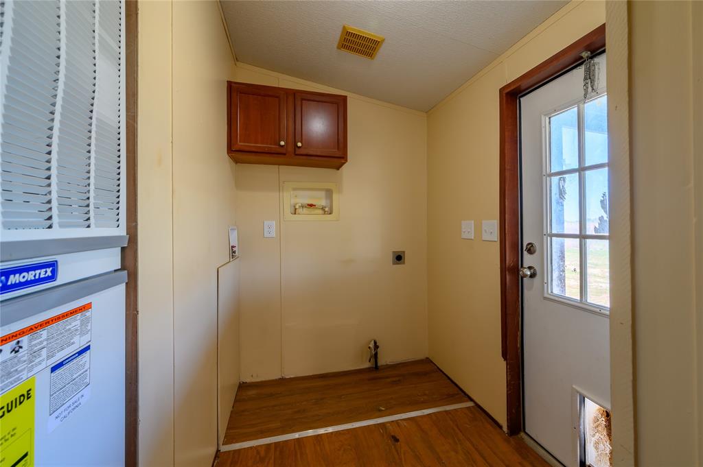 383 Soaring Eagle Trail Wichita Falls, TX 76310 - Photo 23 of 36 Laundry area featuring washer hookup, cabinet space, wood finished floors, a heating unit, and vaulted ceiling