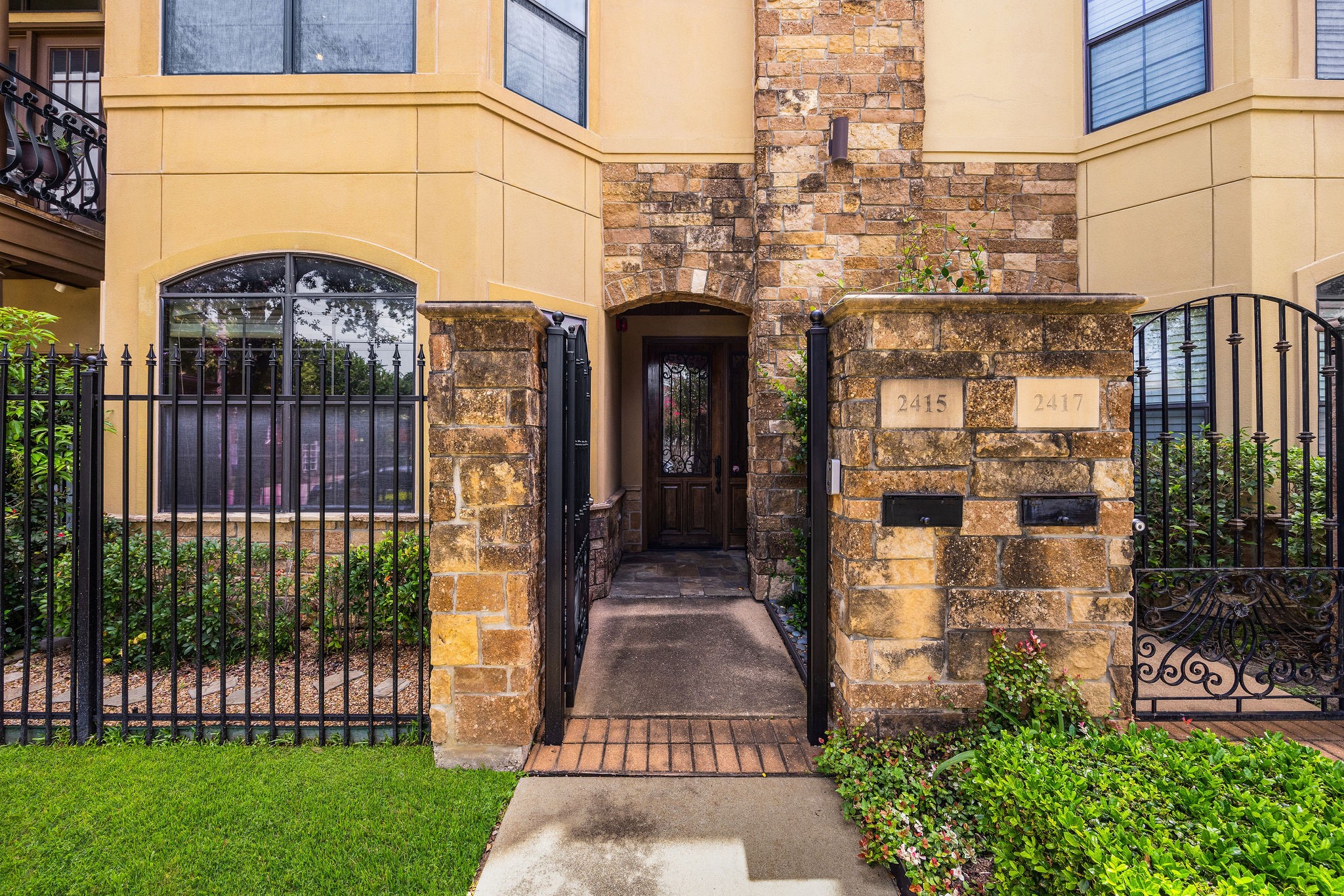 2415 Commonwealth Street Houston, TX 77006 - Photo 25 of 26 A private gated entrance and impressive stone façade create a memorable first impression, welcoming you home in the heart of Montrose.