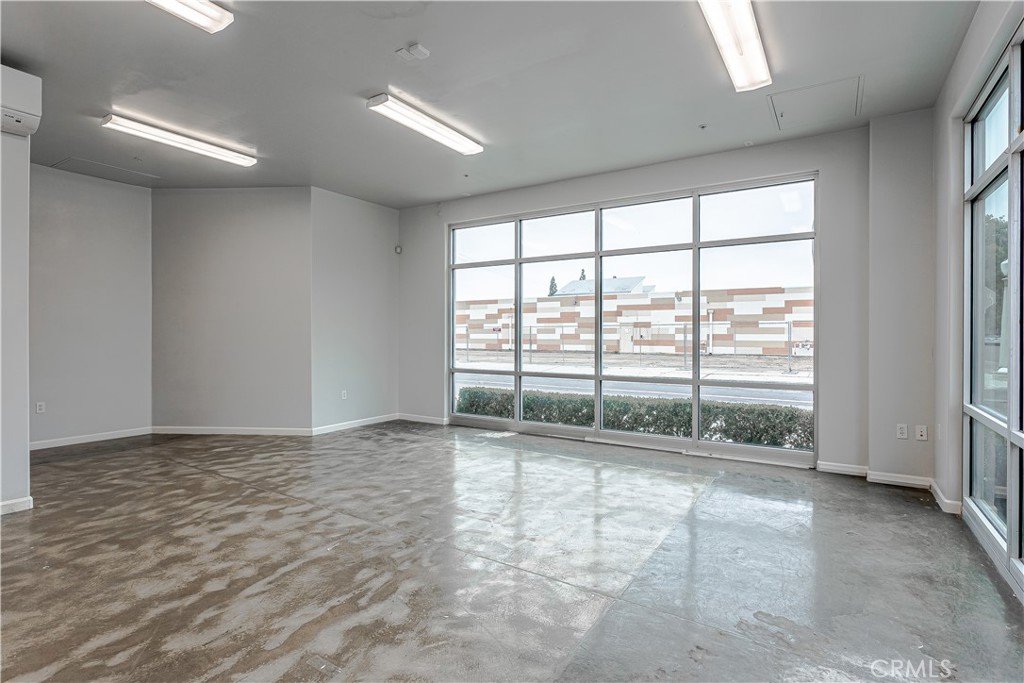 1759 Fulton Street Fresno, CA 93721 - Photo 12 of 24 a view of an empty room with wooden floor and a window
