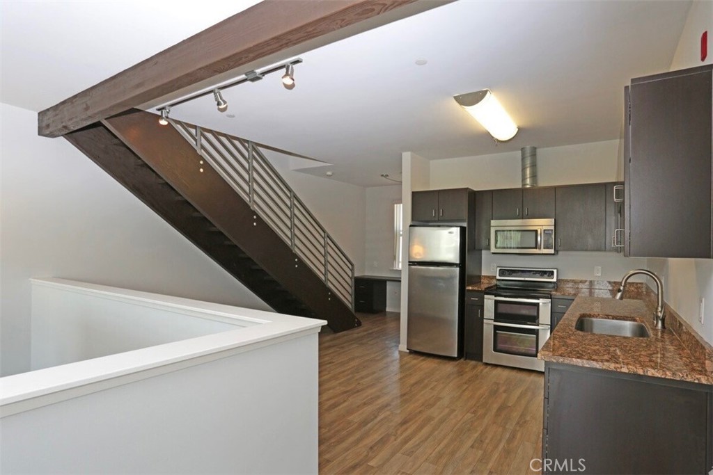1759 Fulton Street Fresno, CA 93721 - Photo 19 of 24 a kitchen with granite countertop a refrigerator and a stove top oven