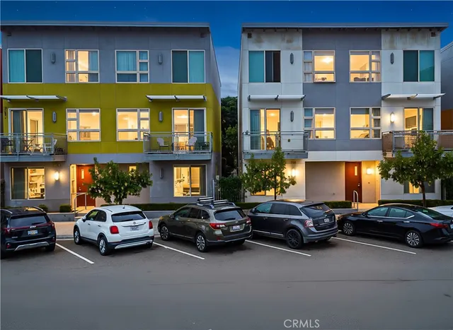 a couple of cars parked in front of a building