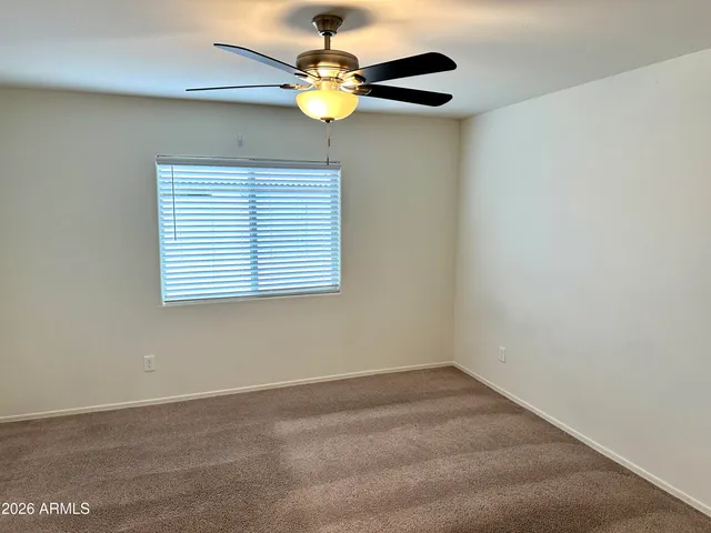 an empty room with a fan