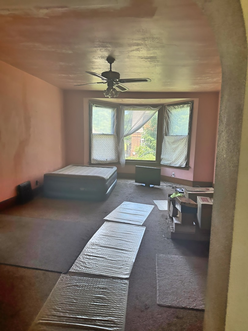 313 North 5th Street Watseka, IL 60970 - Photo 10 of 16 a bedroom with a large bed and a chandelier