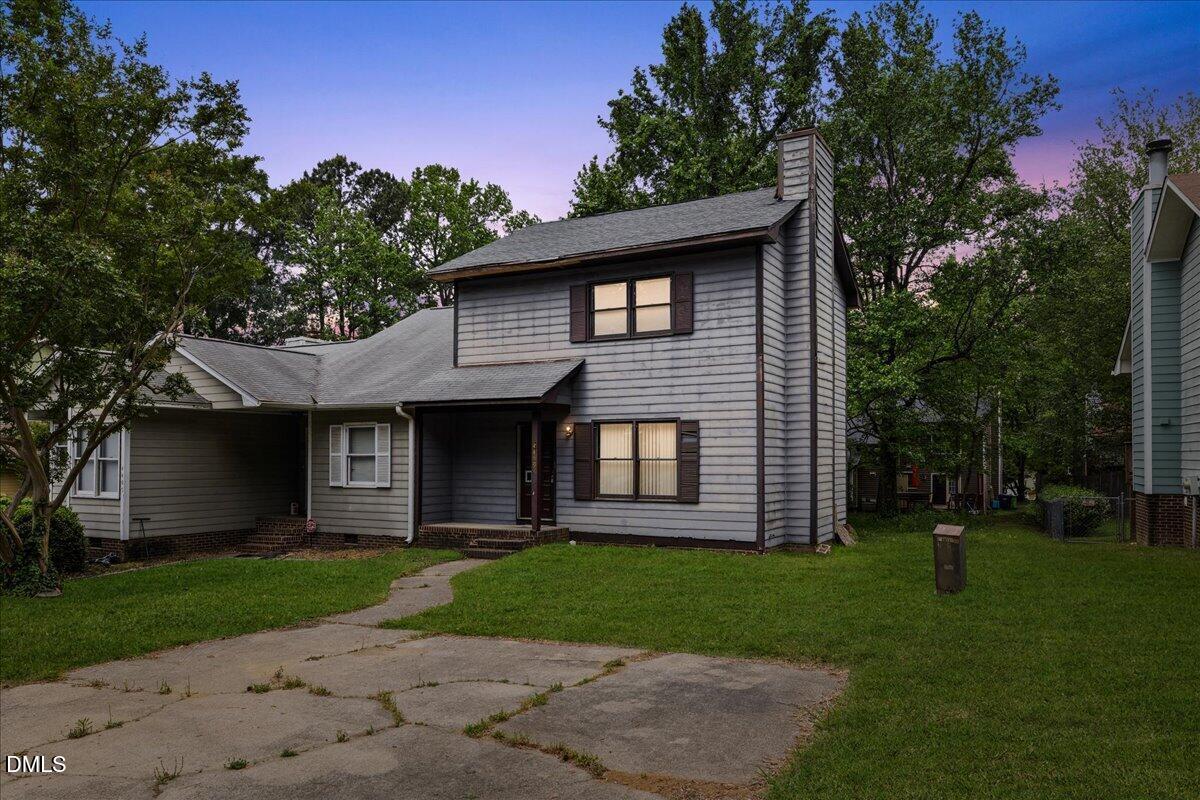 4409 Lake Ridge Drive Raleigh, NC 27604 - Photo 1 of 31 a front view of a house with a garden