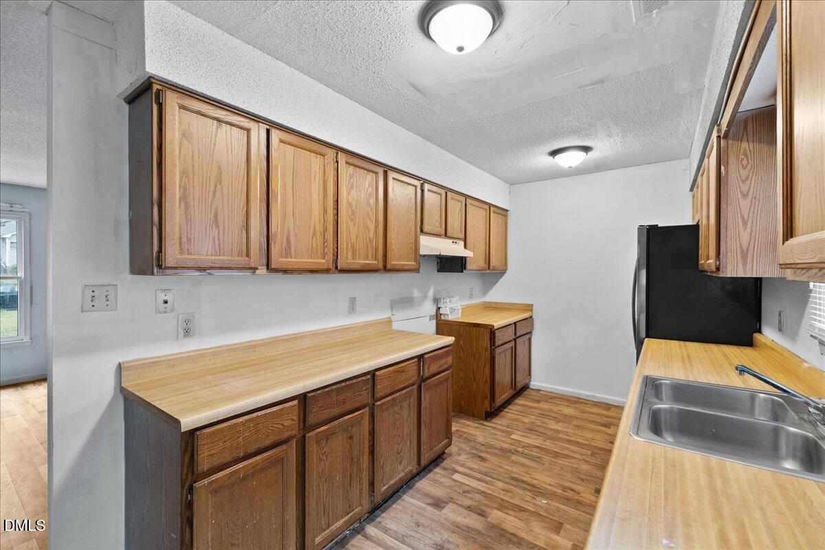 4409 Lake Ridge Drive Raleigh, NC 27604 - Photo 12 of 31 a kitchen that has a sink and a stove in it