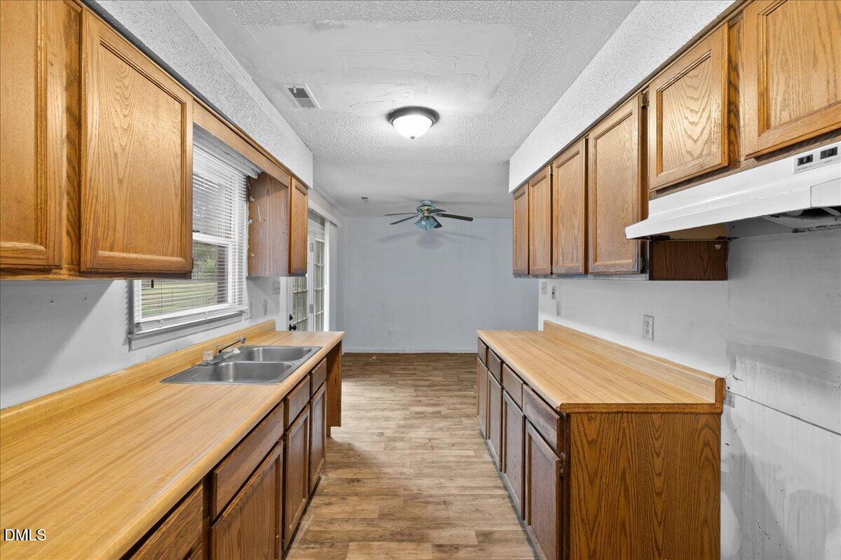 4409 Lake Ridge Drive Raleigh, NC 27604 - Photo 15 of 31 a kitchen with a sink stove and cabinets