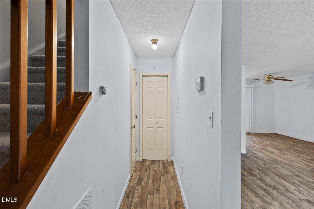 4409 Lake Ridge Drive Raleigh, NC 27604 - Photo 16 of 31 a view of a hallway with wooden floor and staircase