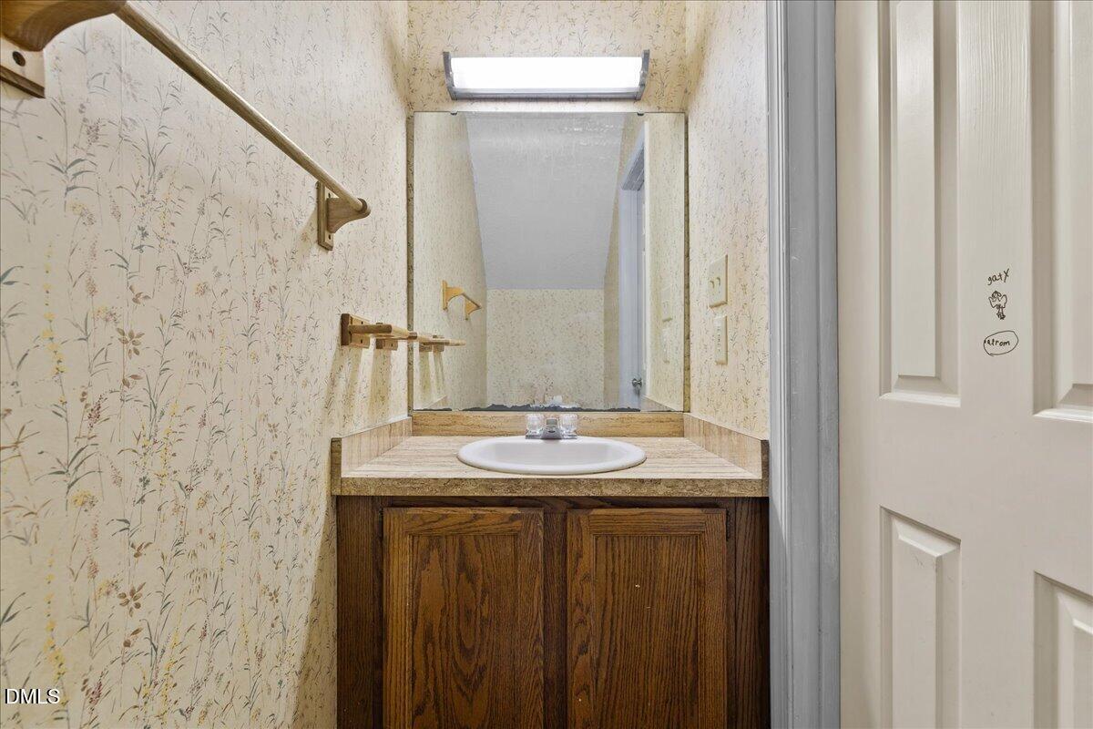 4409 Lake Ridge Drive Raleigh, NC 27604 - Photo 17 of 31 a bathroom with a sink and a mirror