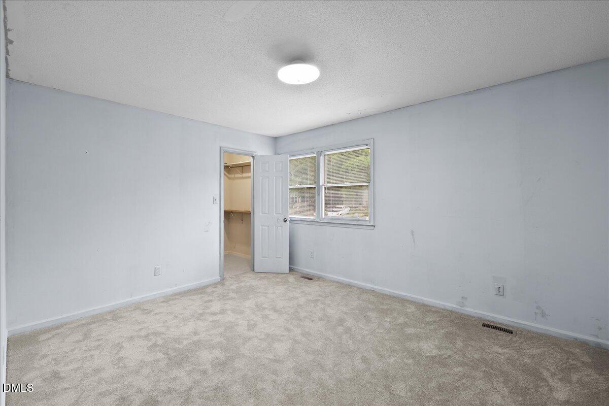 4409 Lake Ridge Drive Raleigh, NC 27604 - Photo 19 of 31 an empty room with windows and closet