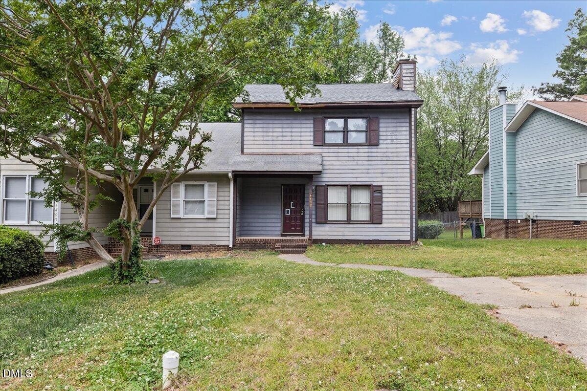 4409 Lake Ridge Drive Raleigh, NC 27604 - Photo 2 of 31 a front view of a house with a garden and trees