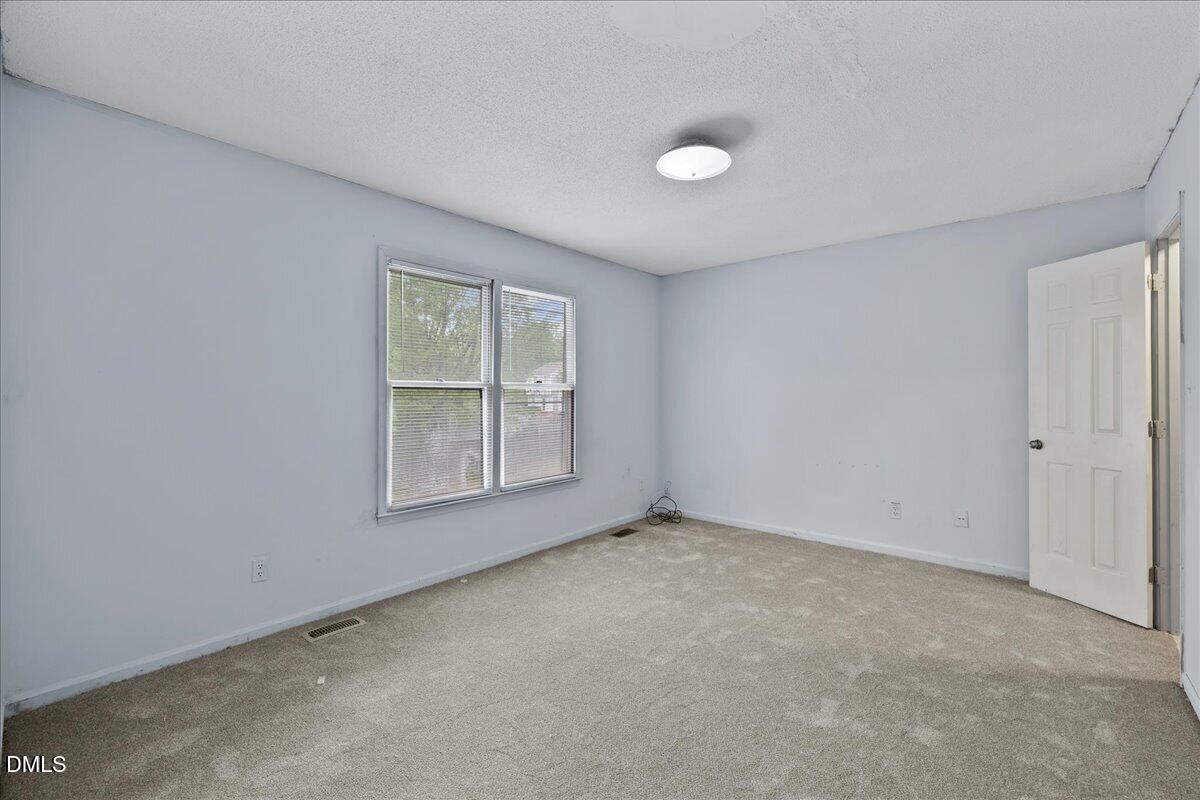 4409 Lake Ridge Drive Raleigh, NC 27604 - Photo 25 of 31 an empty room with a window