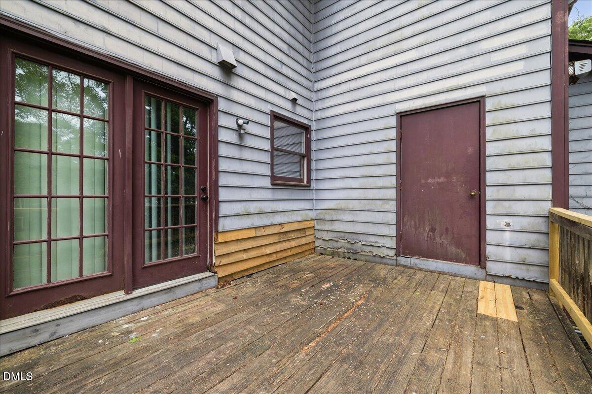 4409 Lake Ridge Drive Raleigh, NC 27604 - Photo 28 of 31 a view of a porch with wooden floor and floor to ceiling window