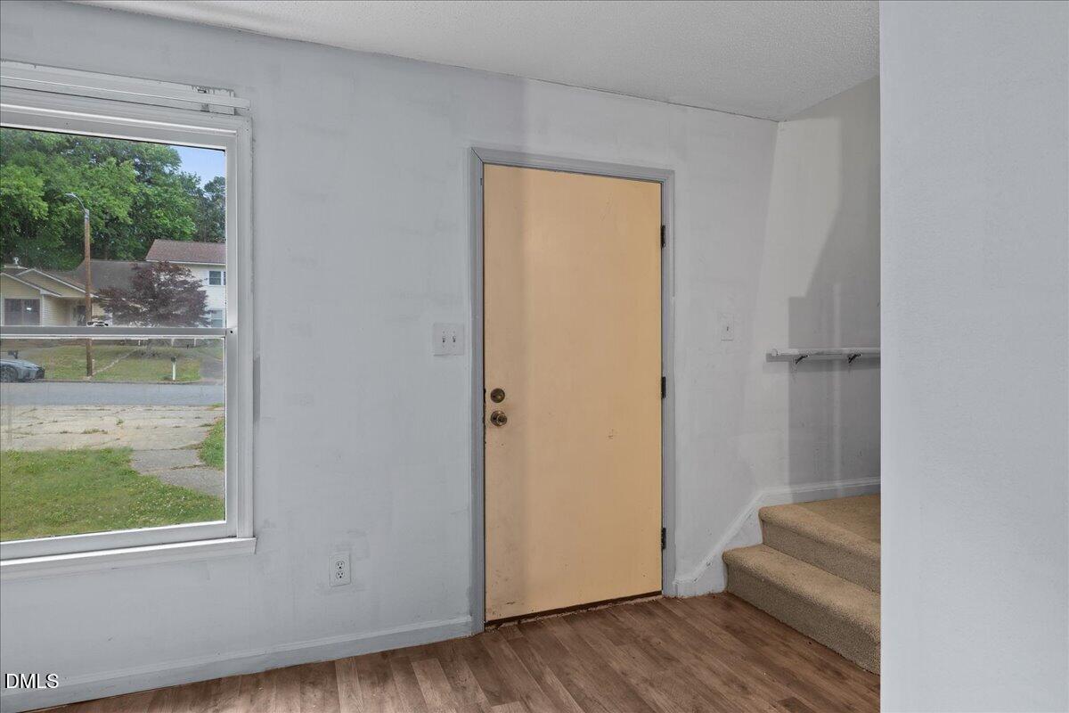 4409 Lake Ridge Drive Raleigh, NC 27604 - Photo 5 of 31 a view of hallway with window and wooden floor