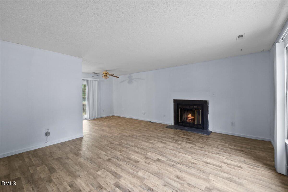 4409 Lake Ridge Drive Raleigh, NC 27604 - Photo 6 of 31 a view of empty room with wooden floor