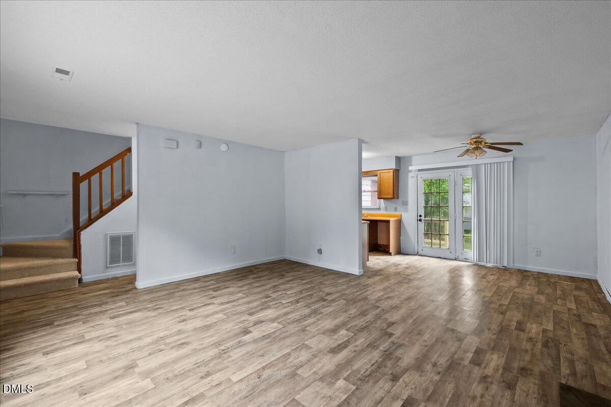 4409 Lake Ridge Drive Raleigh, NC 27604 - Photo 9 of 31 a view of an empty room with wooden floor and a window