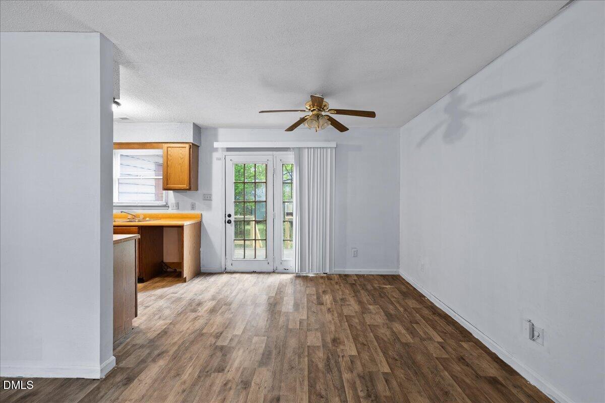 4409 Lake Ridge Drive Raleigh, NC 27604 - Photo 10 of 31 a view of a hallway with wooden floor and a kitchen