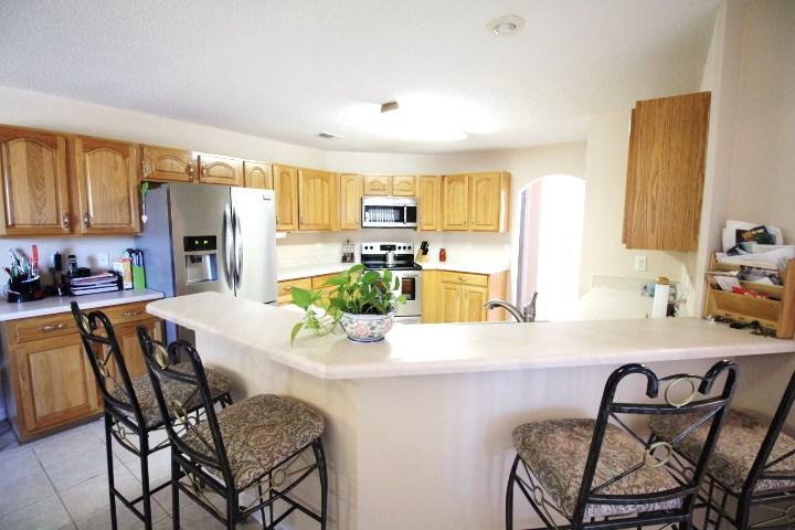 702 Riva Ridge Drive Crestview, FL 32539 - Photo 8 of 20 a kitchen with a dining table chairs and refrigerator