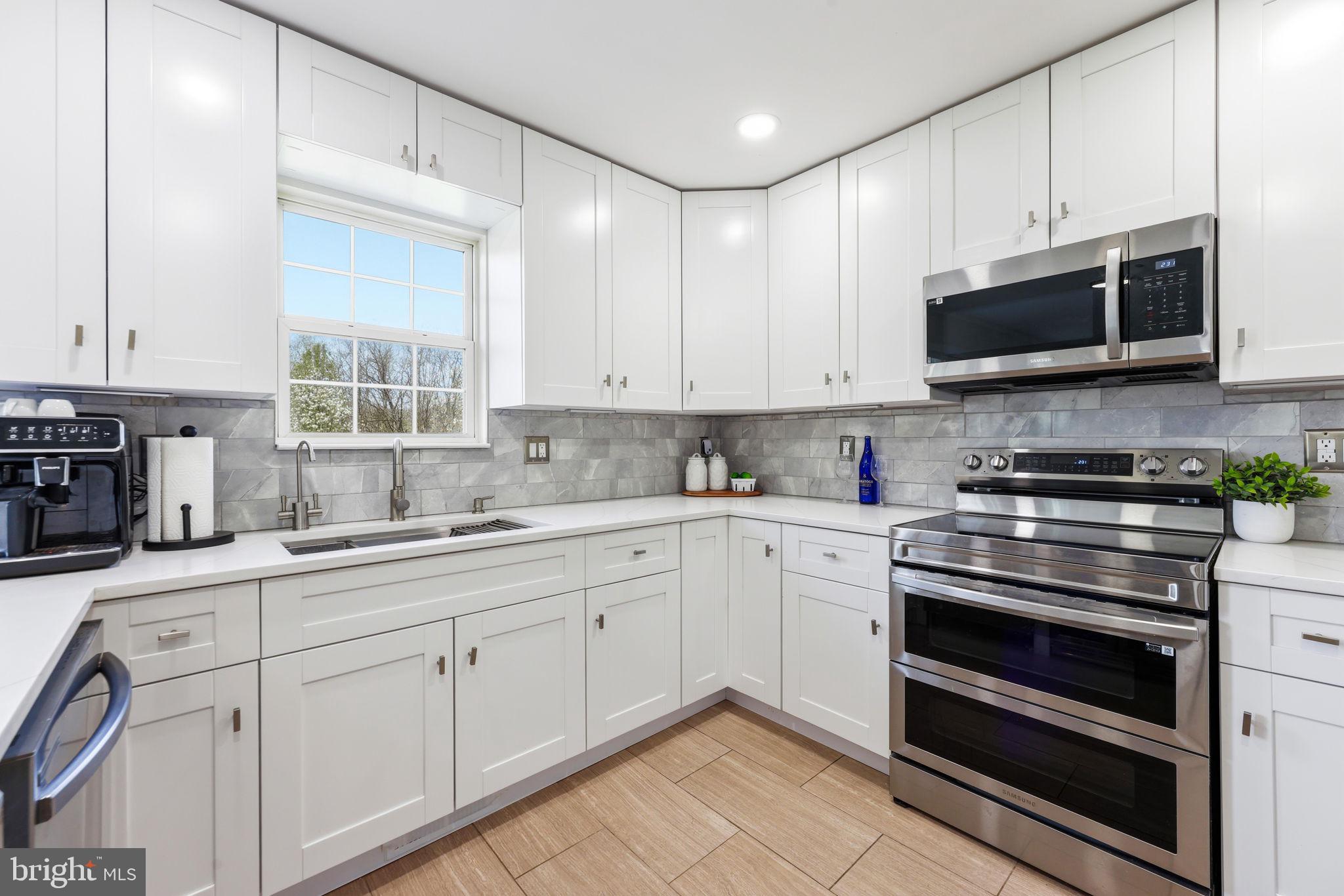 1439 Goodwood Avenue Baltimore, MD 21221 - Photo 19 of 49 a kitchen with stainless steel appliances granite countertop a stove and a sink