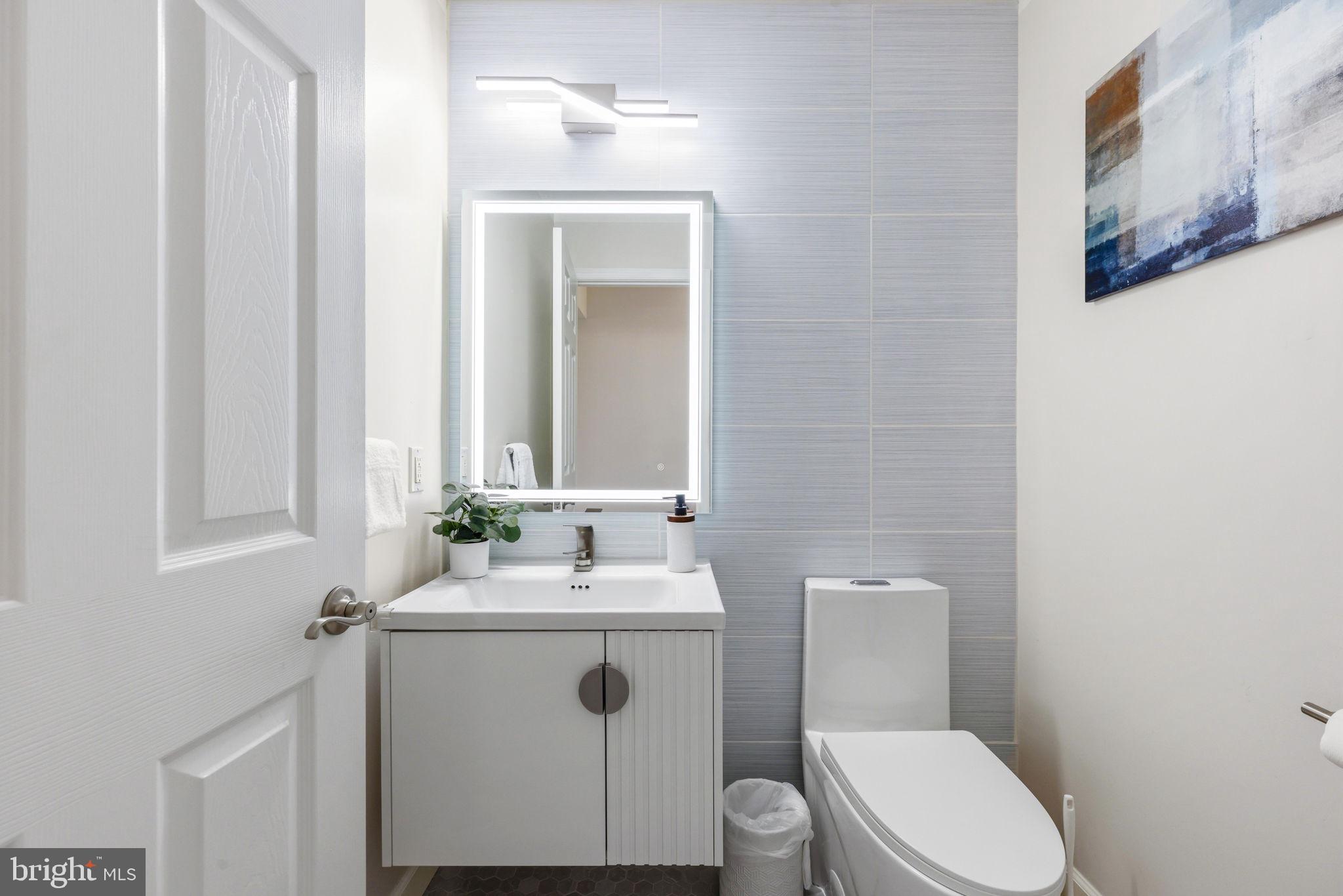 1439 Goodwood Avenue Baltimore, MD 21221 - Photo 23 of 49 a bathroom with a toilet sink and mirror