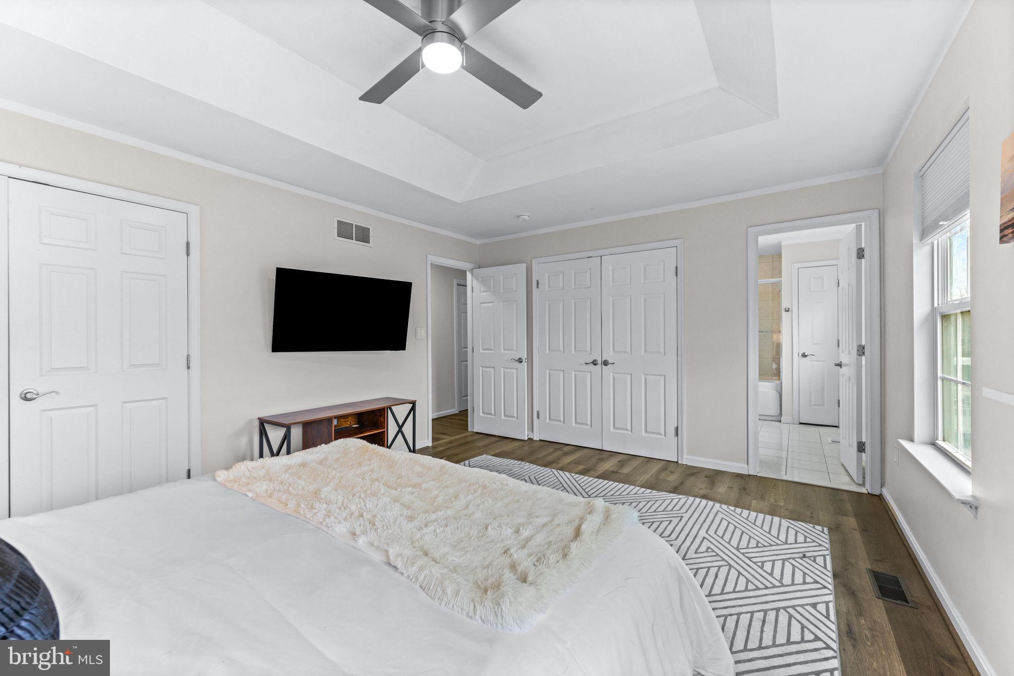 1439 Goodwood Avenue Baltimore, MD 21221 - Photo 28 of 49 a bedroom with a bed and a flat tv screen on wall