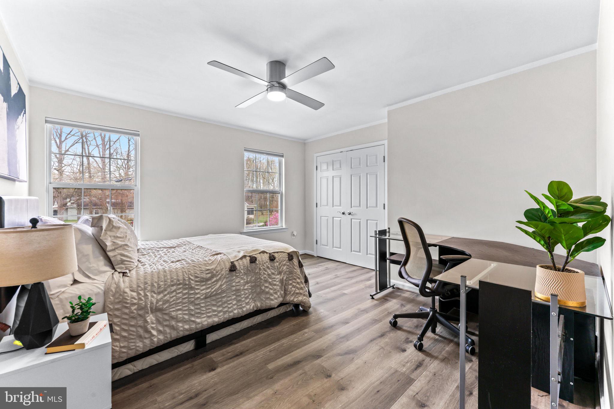 1439 Goodwood Avenue Baltimore, MD 21221 - Photo 32 of 49 a bedroom with a bed table chair and a window