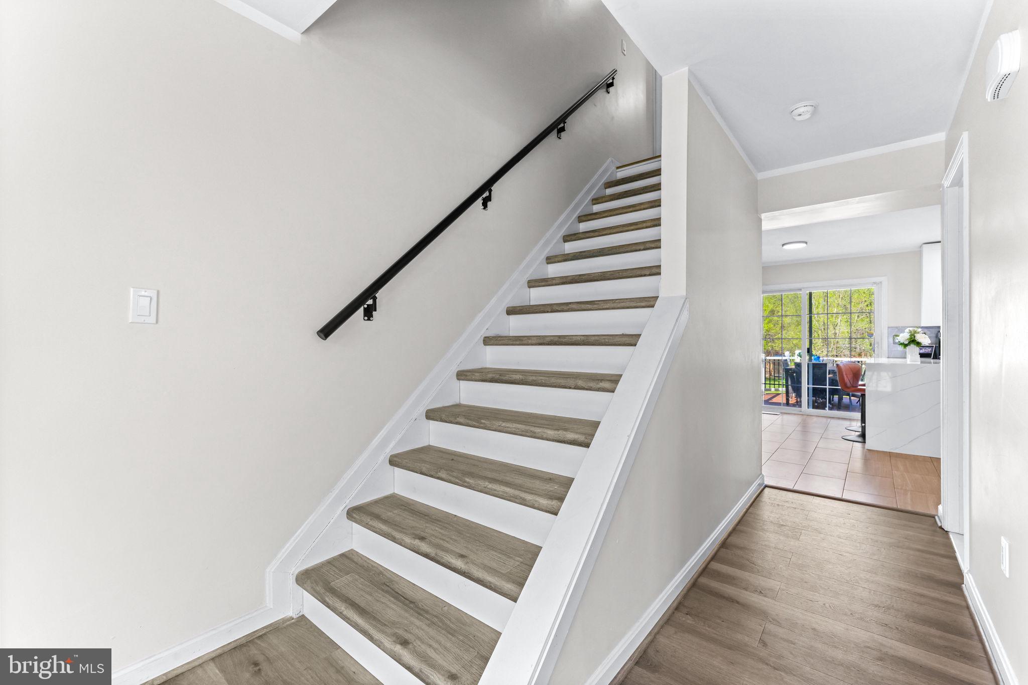 1439 Goodwood Avenue Baltimore, MD 21221 - Photo 9 of 49 a view of a hallway with wooden floor and staircase